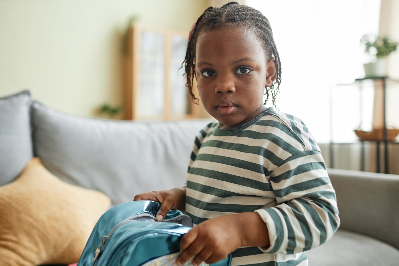 Close up portrait of cute black child looking at camera