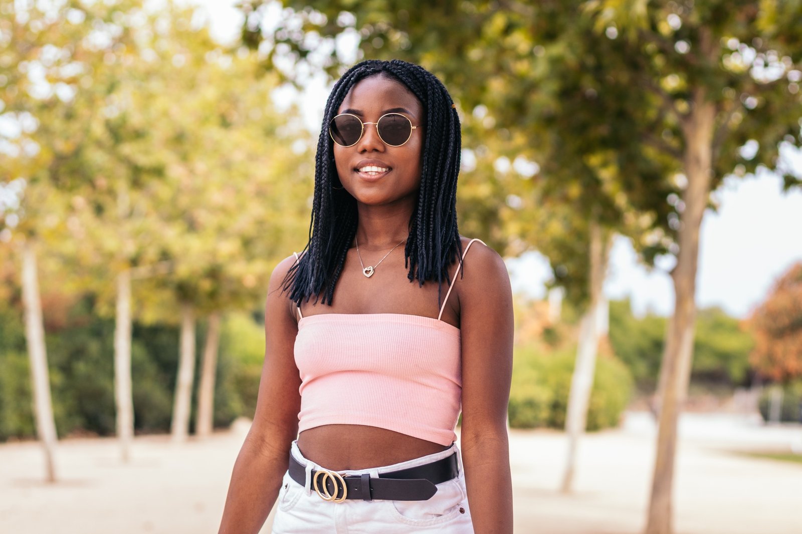 Portrait of an African American woman with braids in a park in summer